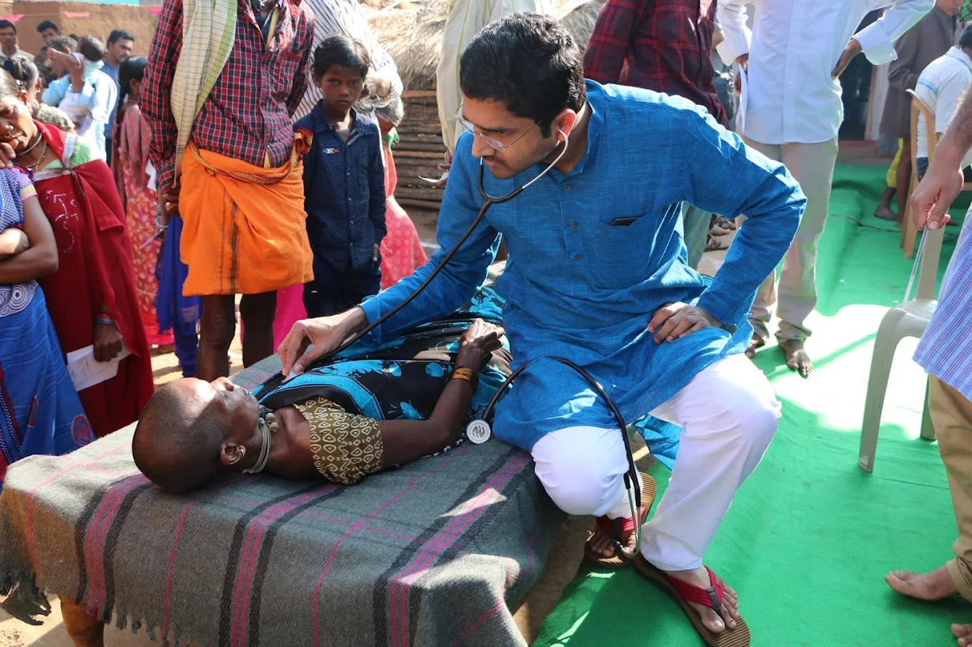 Dr. Raghu Kishore at Cygnet Superspeciality Clinics providing cardiac health check-ups and heart status monitoring for underprivileged patients as part of a community outreach program.